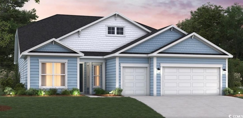 Craftsman-style house featuring concrete driveway and a lawn