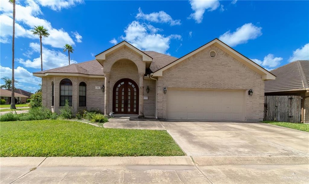 View of front facade with a front lawn and a garage