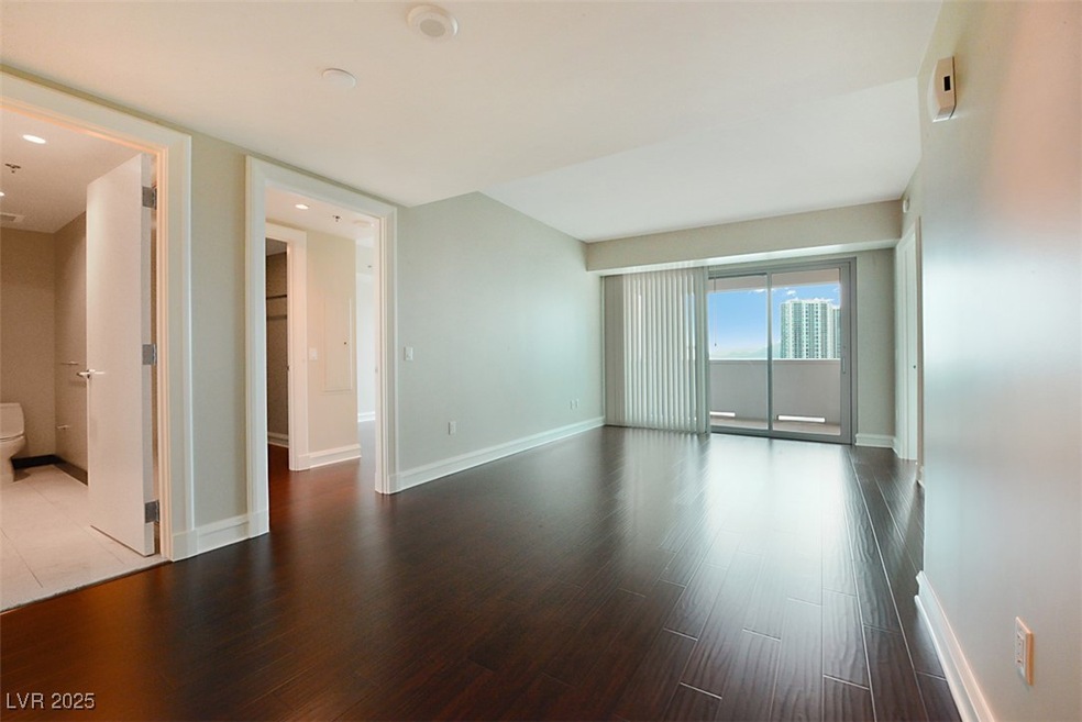 Unfurnished room with wood finished floors and bas