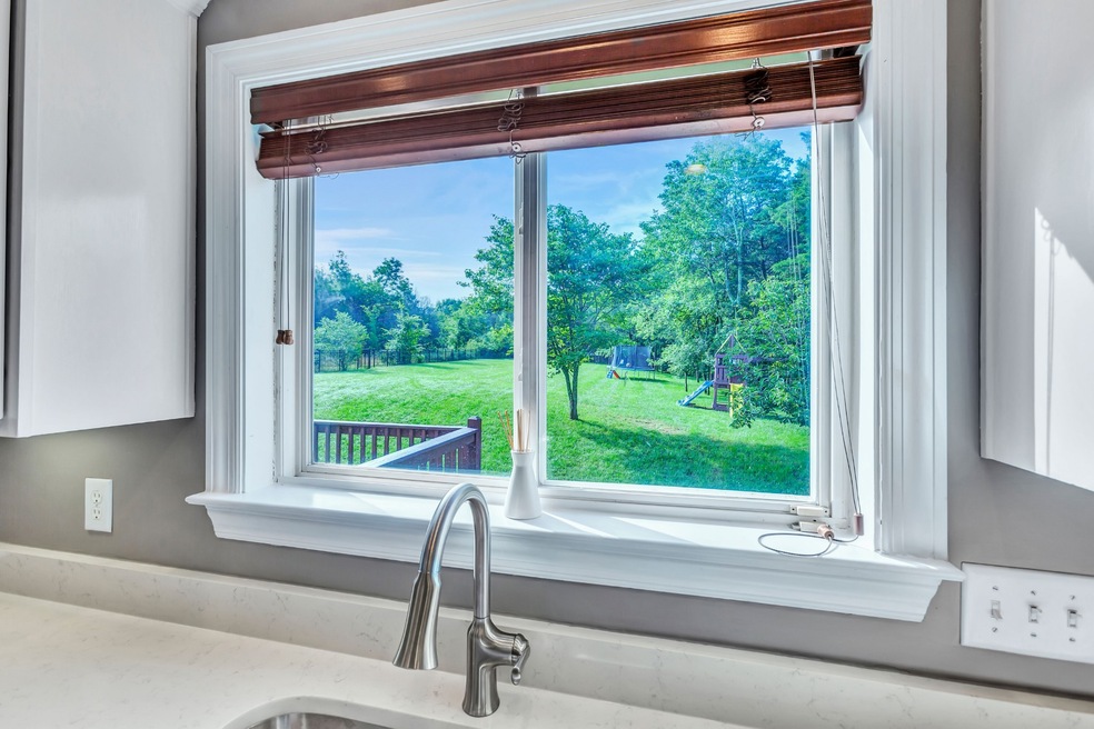 Enjoy your beautiful park-like backyard through your kitchen window.