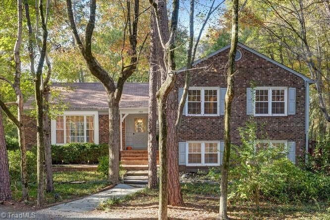 Welcome to an oasis in the woods.  A charming home nestled on an unbelievable lot in Northwest Greensboro.