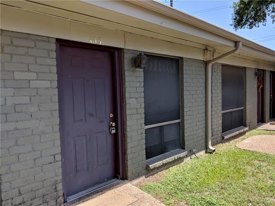 View of exterior entry with brick siding