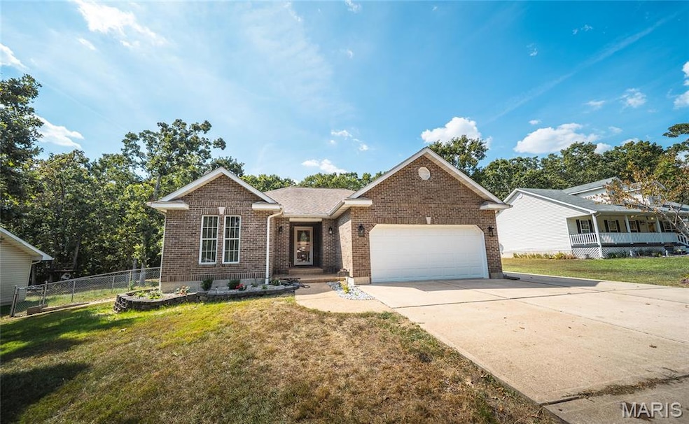 Single story home featuring brick siding, concrete driveway, and a garage