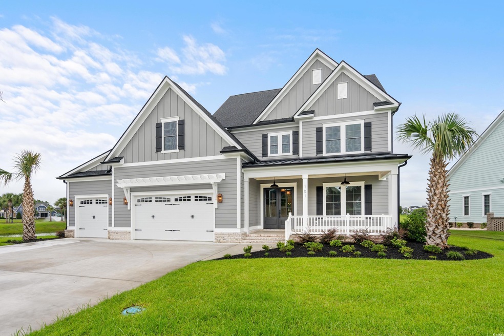 Craftsman-style home featuring covered porch, a ga