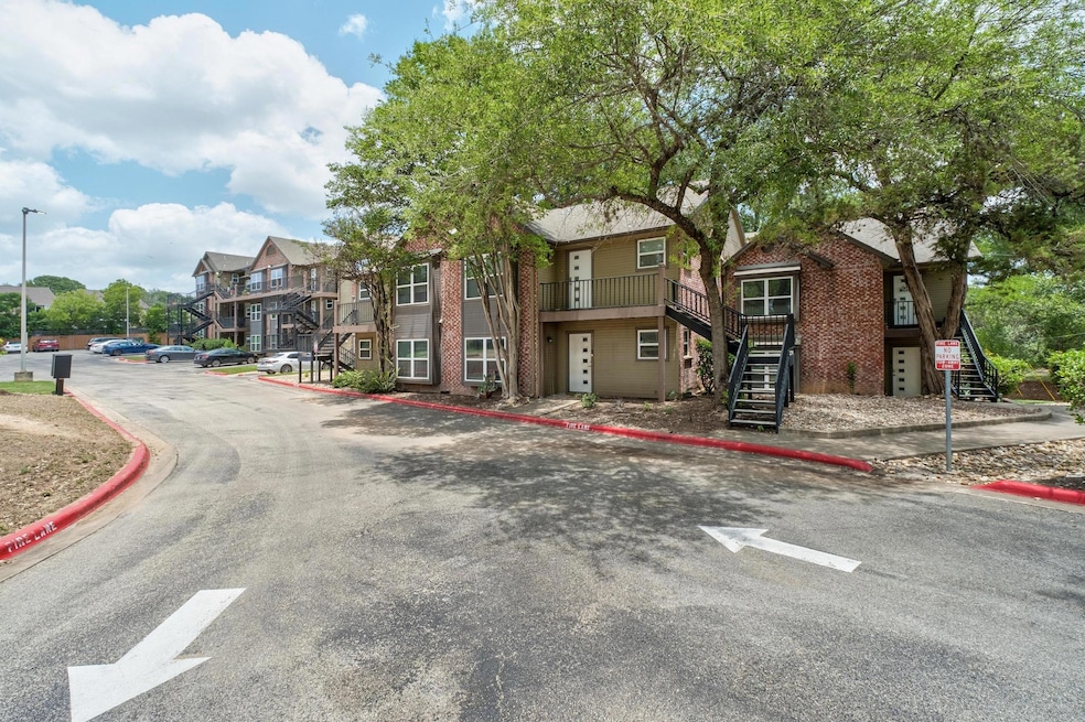 View of asphalt road featuring stairway, curbs, a