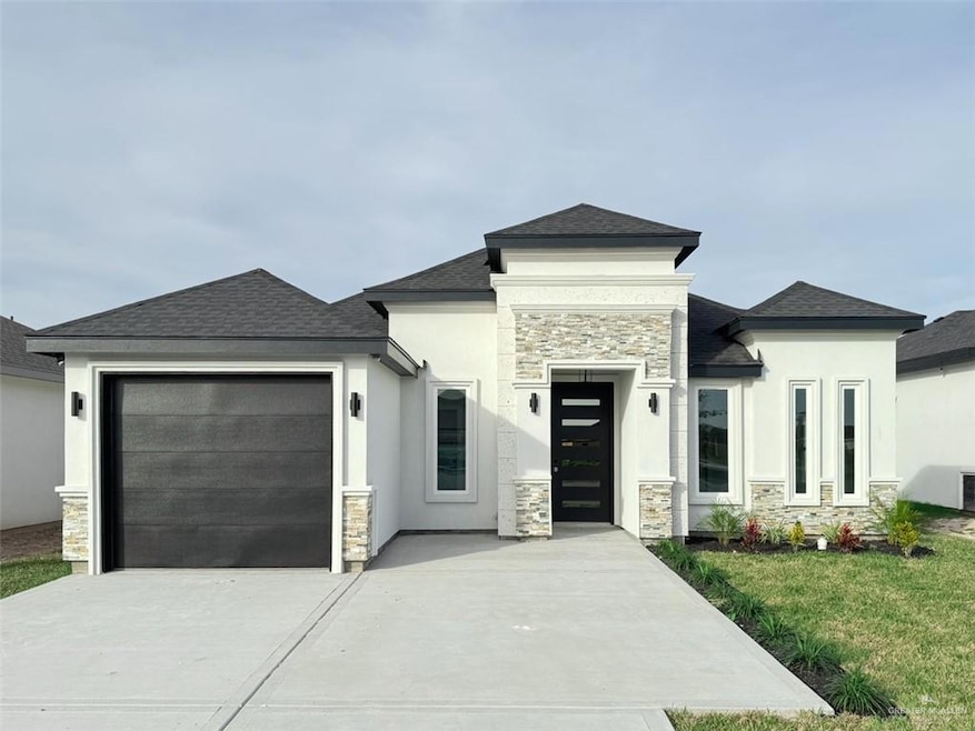 Prairie-style house featuring a front lawn and a garage