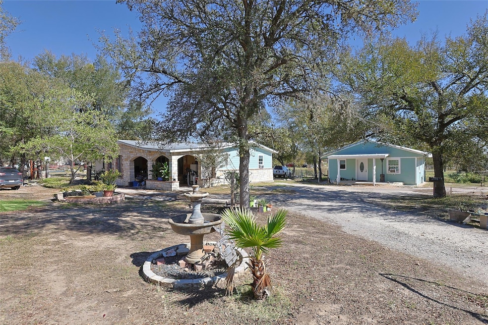 View of front of home featuring dirt driveway