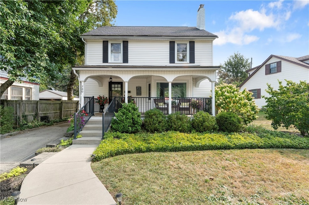 View of front of house with covered porch, a chimney, and a front yard