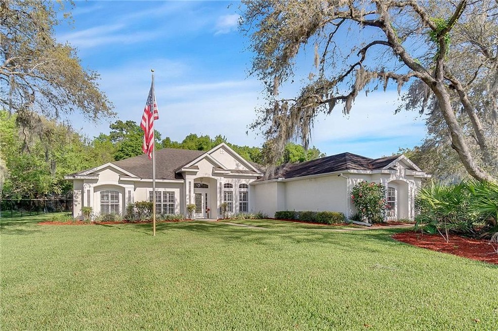 Gorgeous home with green lawn and updated landscaping