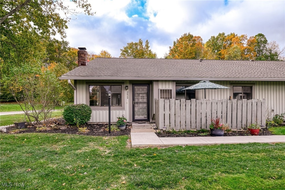 View of front of home featuring a shingled roof, a chimney, and board and batten siding