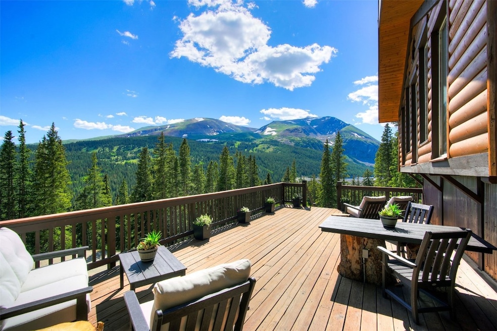 Wooden deck with a mountain view and a wooded view