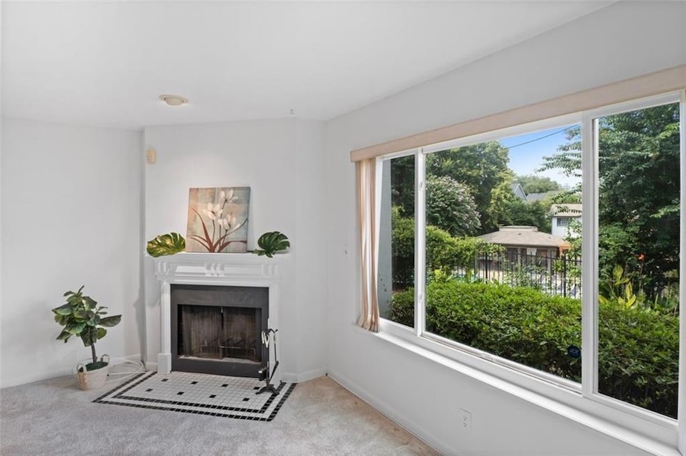 Sunny, open concept living room with oversized picture window overlooking greenspace!