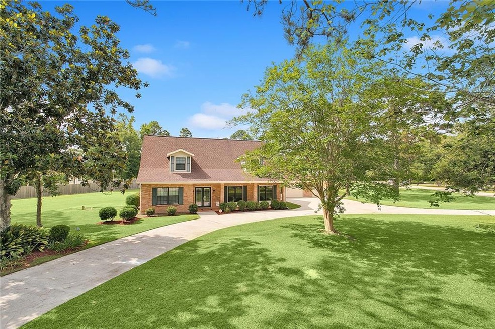 Beautiful front of home with half circular drive