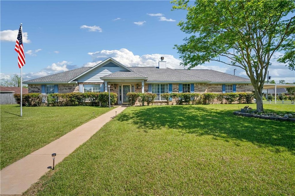 Ranch-style home with a chimney, a front yard, and