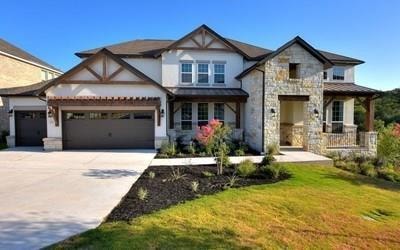 View of front of house featuring a garage, concre