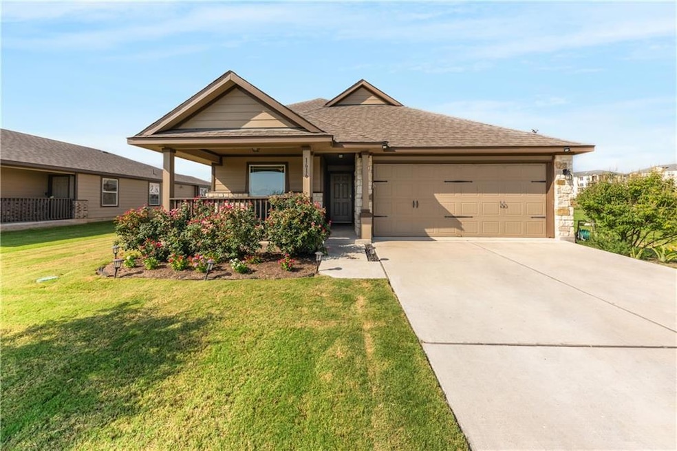 Single story home featuring a garage, driveway, a