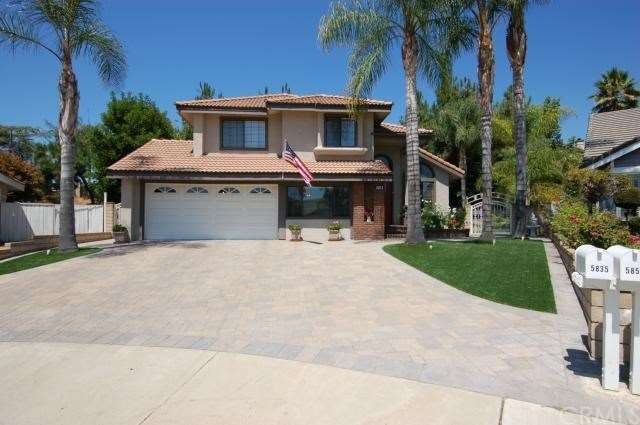 Front of home showing oversized paver driveway