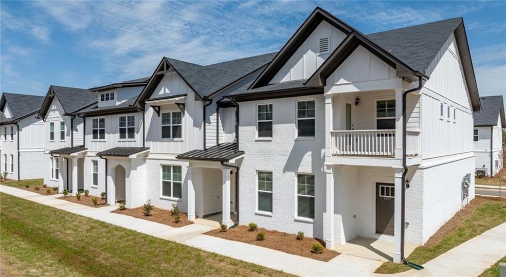 View of property with a standing seam roof, a balcony, board and batten siding, metal roof, and a residential view