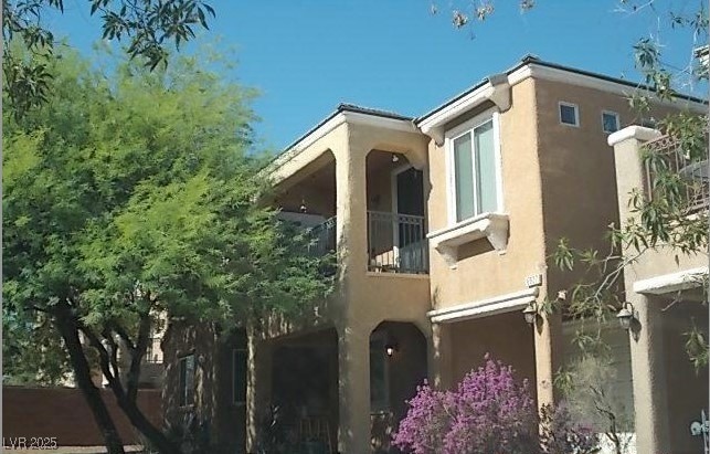 View of property exterior with stucco siding and a