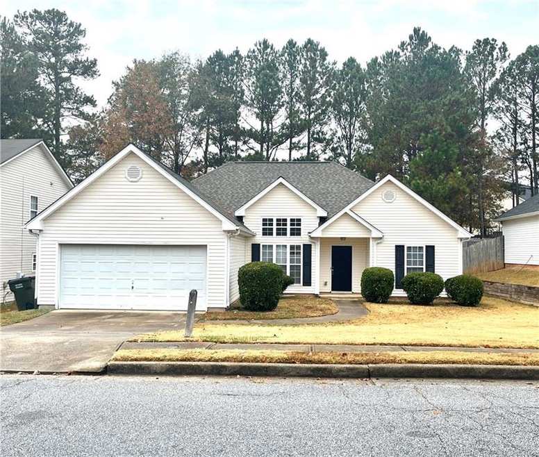 Ranch-style house with a garage and a front yard
