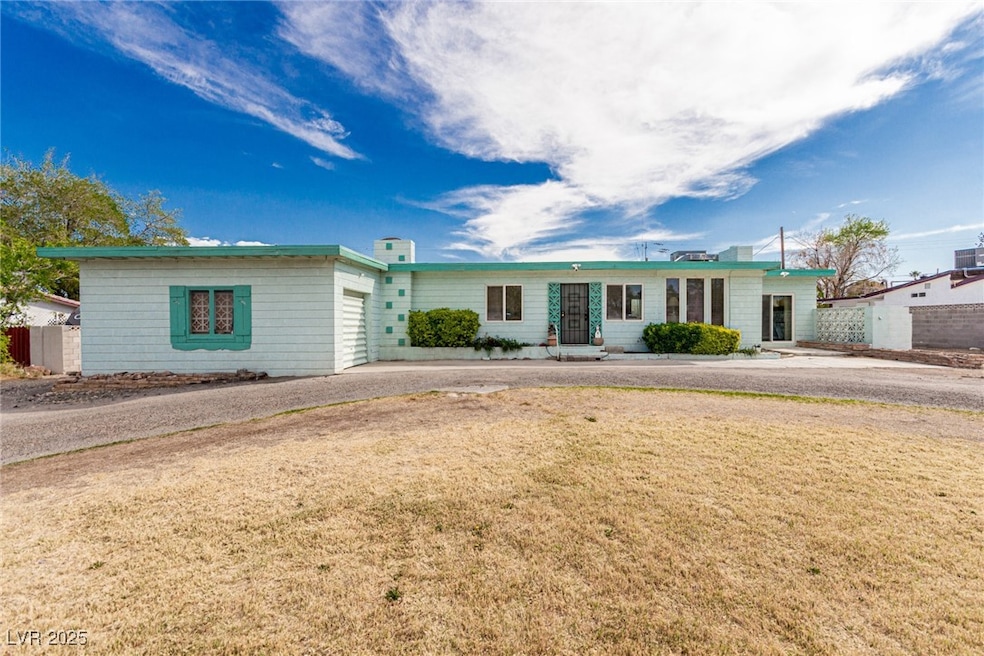 Ranch-style home featuring a front yard, driveway,