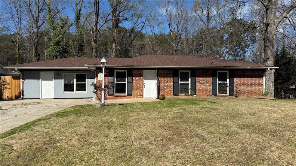 Ranch-style house with a front lawn and fence