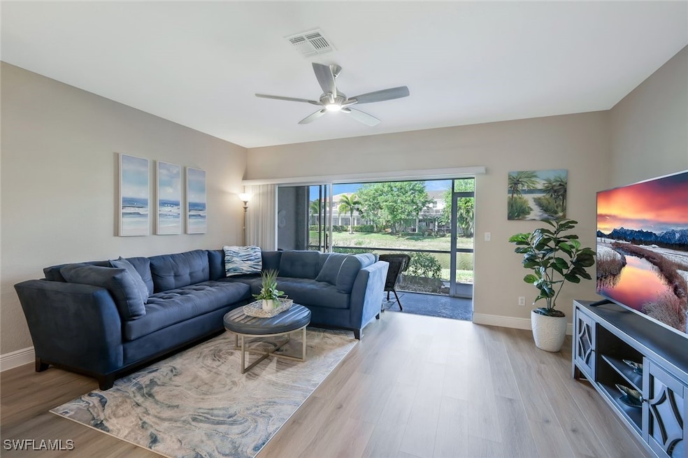 Living room with baseboards, visible vents, a ceil