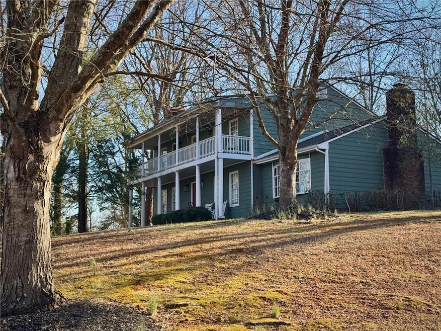 View of front of property with a balcony and a chi