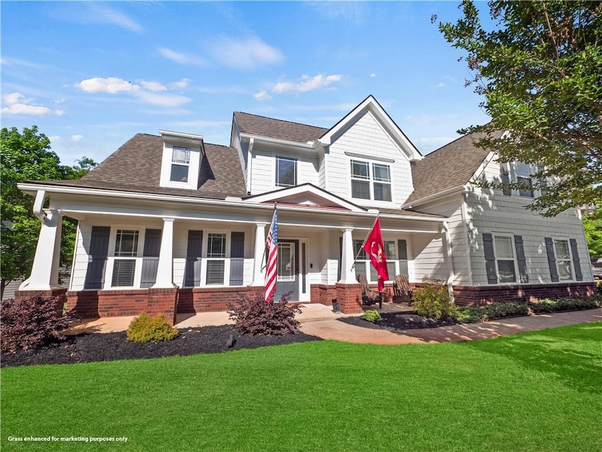 View of front of house with a porch and a front ya
