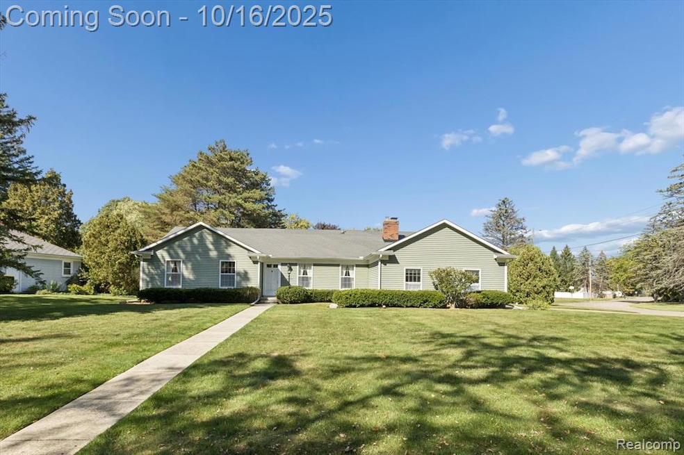 Ranch-style home featuring a front yard and a chimney