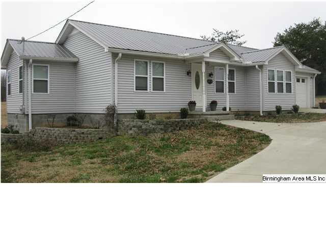 Front view of home with great landscaping and conc