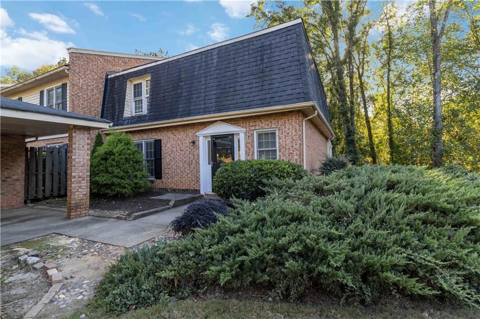 View of front of house featuring brick siding, man