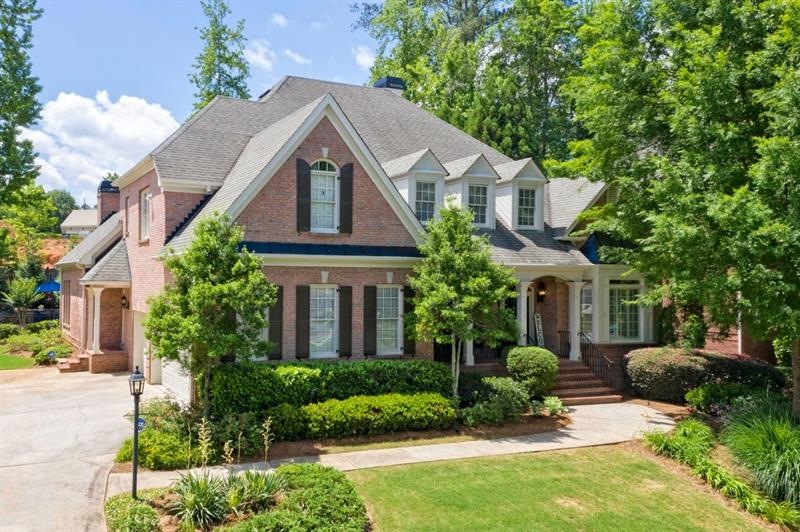 Gorgeous 4 sided brick home with covered front por