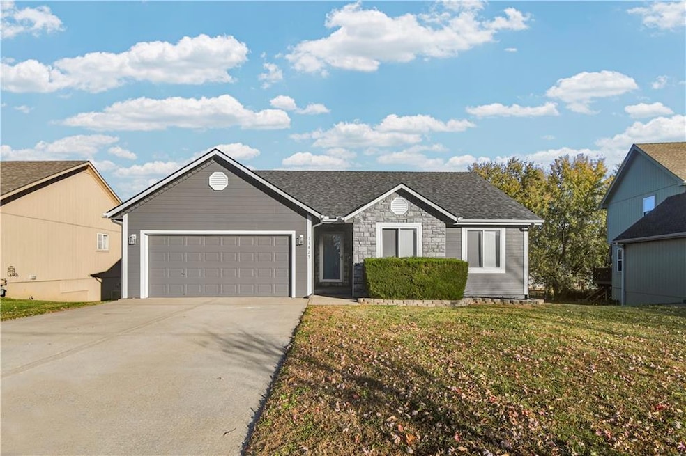 Ranch-style home featuring driveway, a garage, a front lawn, stone siding, and a shingled roof