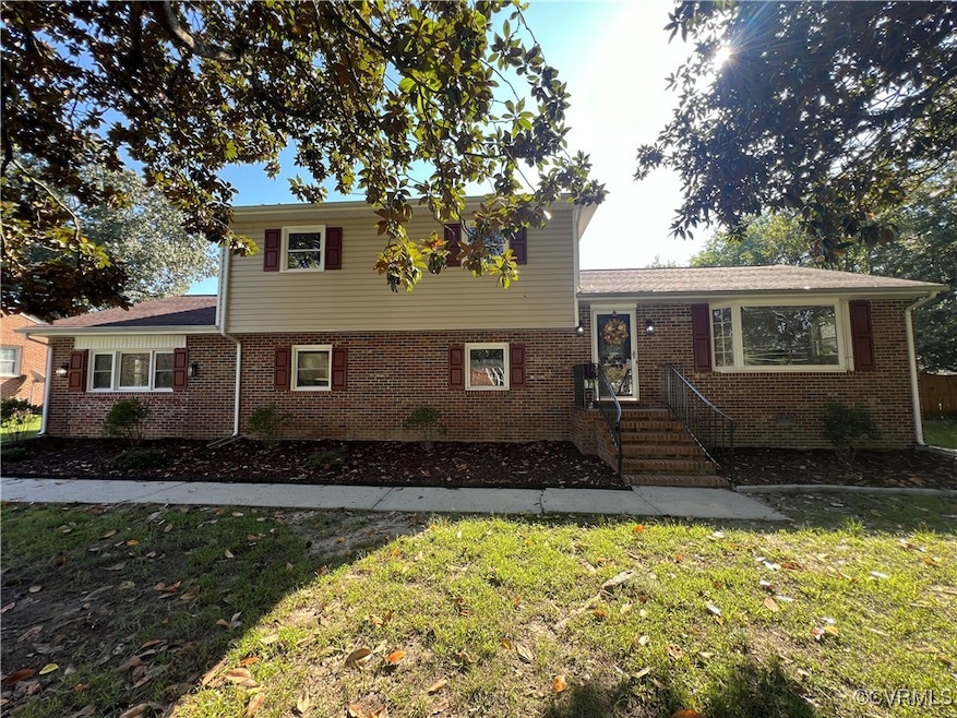 Split level home with a front lawn
