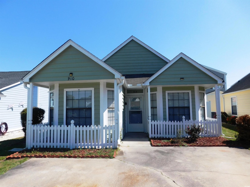 View of front facade with covered porch and a fenc