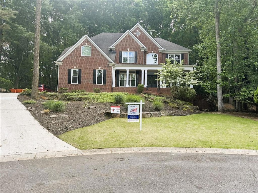 View of front of house with brick siding and a fro