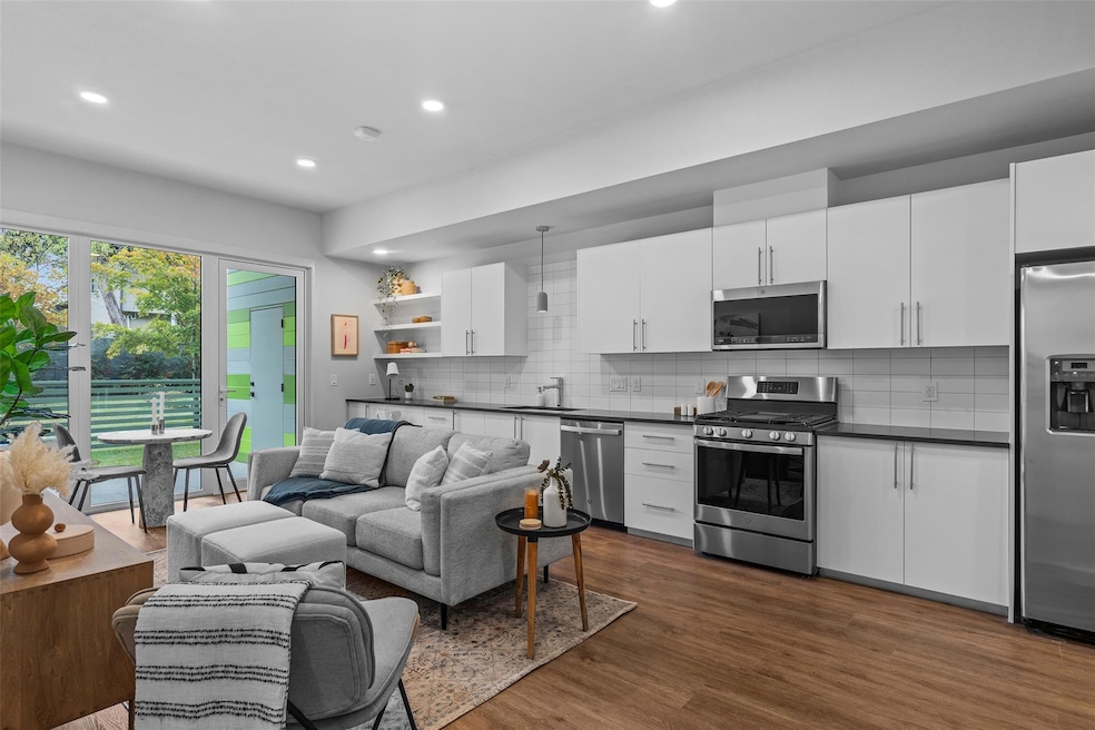 Kitchen with stainless steel appliances, dark cou