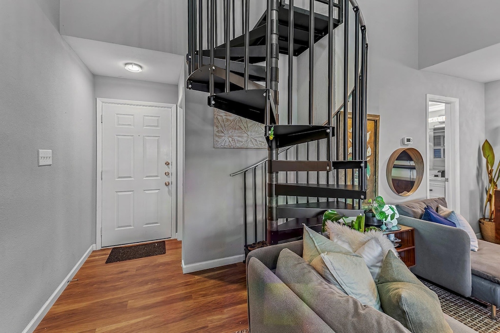 Entrance foyer featuring wood finished floors, ba