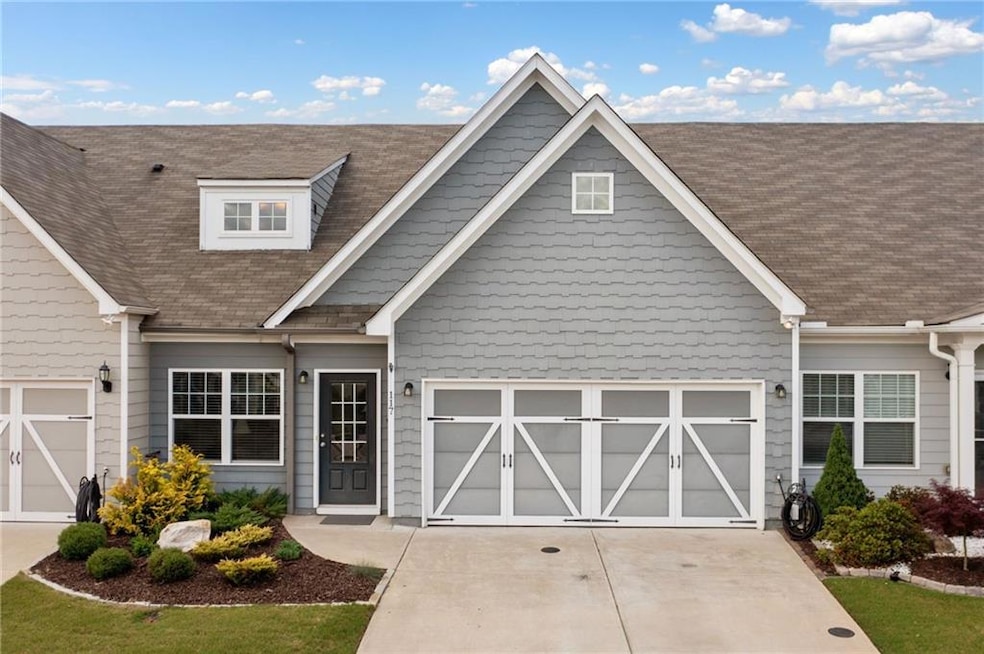 View of front of home with driveway and roof with 