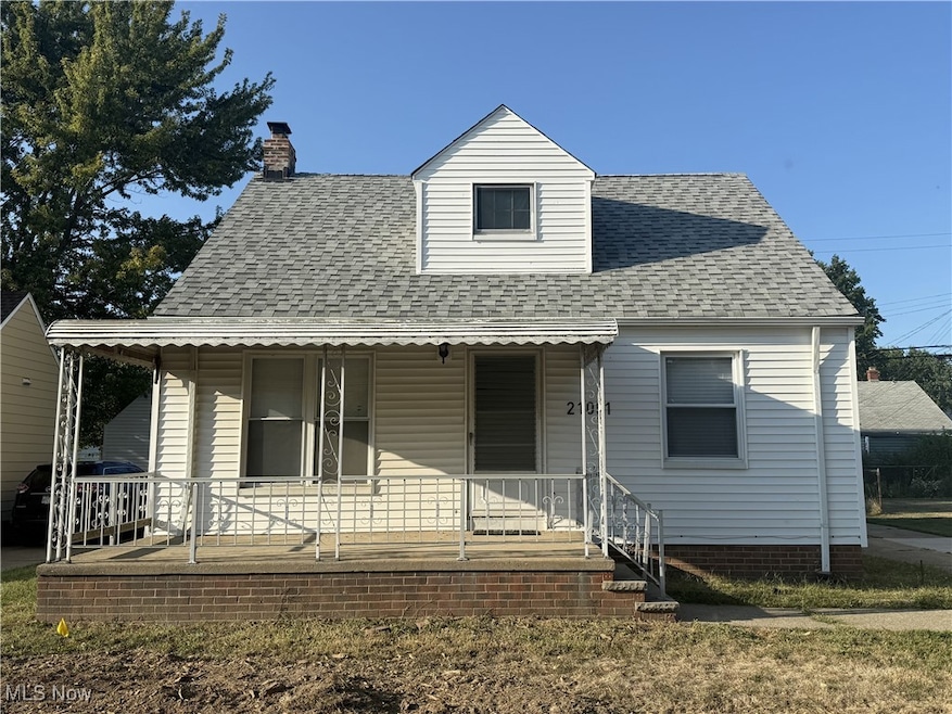 View of front of house with a porch, a shingled roof, and a chimney