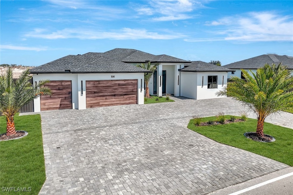 View of front of home with stucco siding, an attac