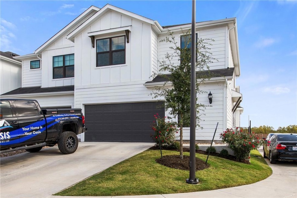 View of front of home featuring a garage, board a