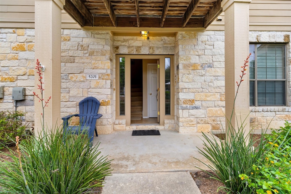 Doorway to property featuring stone siding