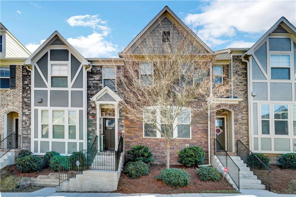 English style home with stone siding and stucco siding