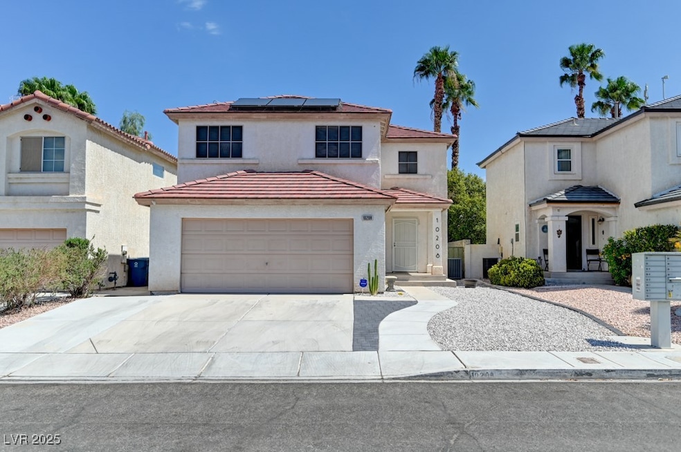 Mediterranean / spanish house featuring roof mounted solar panels, concrete driveway, stucco siding, and a tiled roof