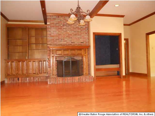 Large den with wood beams, great built-in cabinetr