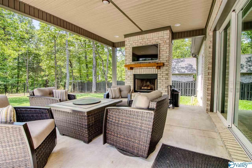 Take the fun outside in just a few steps with this outdoor living space...covered porch, outdoor fireplace, and a backyard that backs up to LandTrust property!