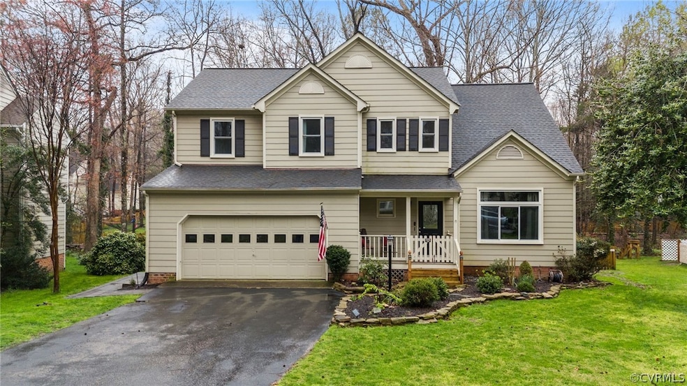 Front facade featuring covered porch, a front lawn