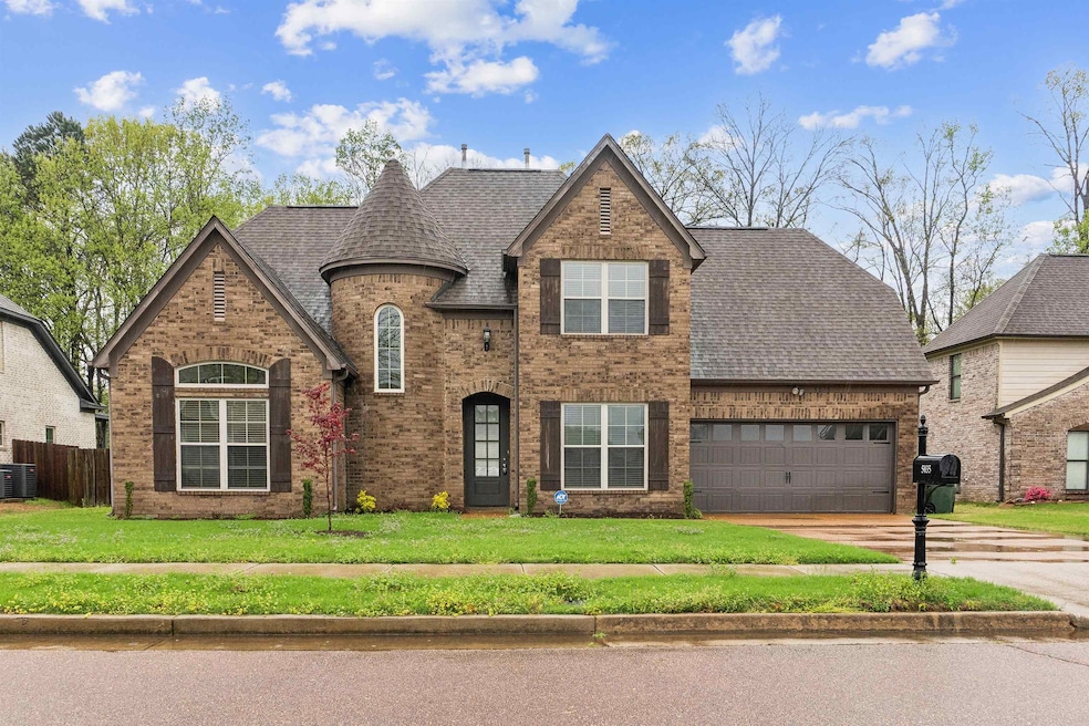 View of front of home with a shingled roof, brick 
